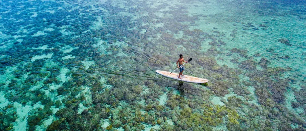 Stand up paddle boardingat Wakatobi Dive Resort.